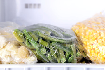 Canvas Print - Frozen vegetables in bags in freezer close up