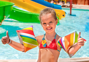 Wall Mural - Child with armbands playing in swimming pool.