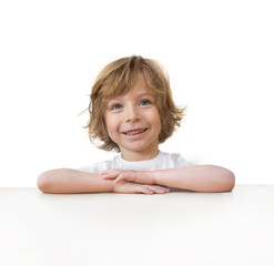adorable little boy on table edge isolated over white background