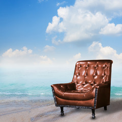 Summer concept. Leather sofa on the beach.