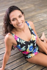 Wall Mural - Pretty brunette sitting in swimwear 