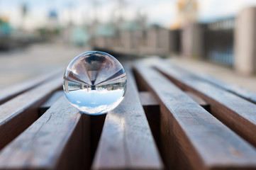 glass transparent ball on wooden slats background. with empty