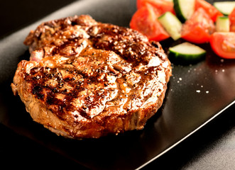 Wall Mural - Grilled steak and vegetables on black plate