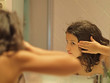 © RooM The Agency - Spain, Barcelona, girl (8-9) looking at reflection in mirror, washing hair