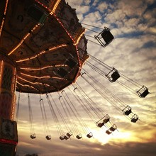 Carousel Ride At An Amusement Park During Sunset