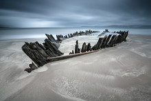 Ireland, Kerry, Rossbeigh Strand, Remnants Of Wooden Rowboat In Beach Sand