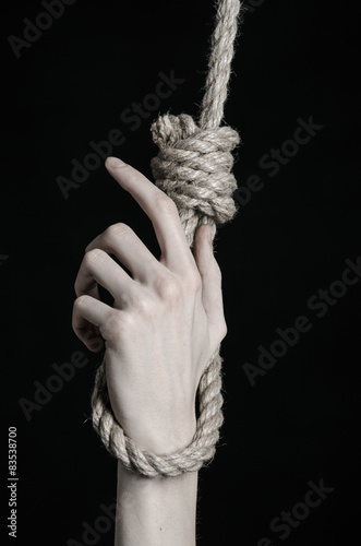 human hand hanging on rope loop on a black background плакат