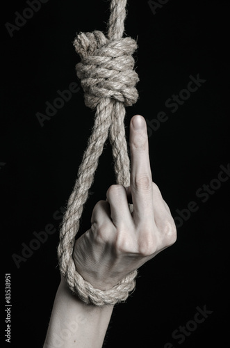 human hand hanging on rope loop on a black background плакат