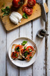 © RooM The Agency - Overhead view of two slices of toast with mozzarella, tomatoes, basil and balsamic vinegar