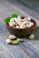 Poster - Pistachios on a wooden table.