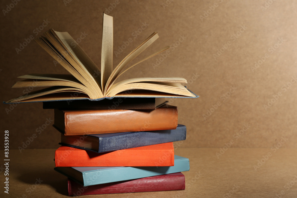Old books on shelf, close-up, on wooden background