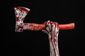 Fototapeta bloody hand holding a bloody butcher's ax isolated in studio