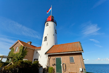 Fototapete - white old lighthouse in Urk