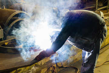 Wall Mural - Welding work during the night a lot of smoke.