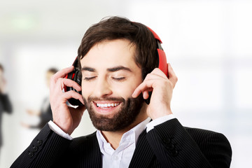 Businessman listening to music.