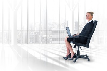 Poster - Businesswoman sitting on chair with laptop 