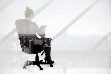 Poster - Businesswoman sitting on swivel chair with tablet 
