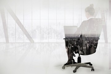 Poster - Businesswoman sitting on chair with laptop