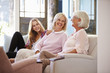 © Monkey Business - Grandmother With Mother And Adult Daughter Relaxing On Sofa