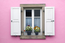 Pink Wall With Window With Shutters And Flower Pots