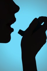 Poster - Composite image of close up of a woman using an asthma inhaler