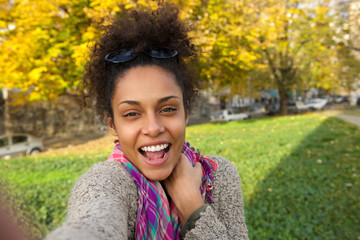 Wall Mural - Selfie portrait of a happy young woman