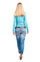 Wall Mural - side view of walking  woman in jeans. beautiful girl in motion.