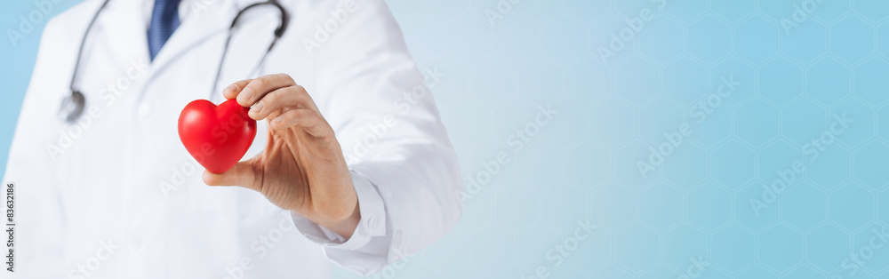 close up of male doctor hand holding red heart - obrazy, fototapety, plakaty 