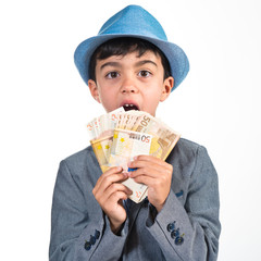 Child doing surprise gesture and holding a lot of money