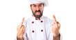 © luismolinero - Chef making horn gesture over white background