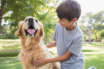 Wall Mural - Little boy with his dog in the park