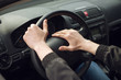 © mrcats - Close-up of  male hand on steering wheel in car