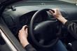 © mrcats - Close-up of  male hand on steering wheel in car