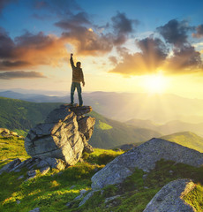Wall Mural - silhouette of a champion on mountain peak. active life concept