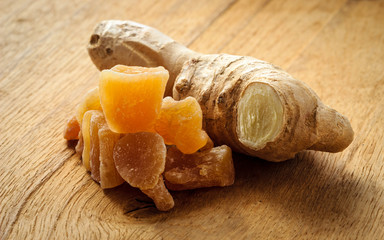 Wall Mural - Closeup root and candied ginger on wooden table