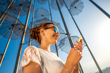 Woman with mobile phone on modern abstract background