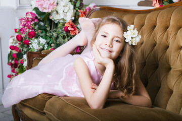 portrait of a little girl lying on the couch