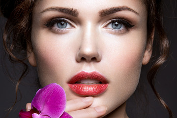 Beautiful girl with violet flower.