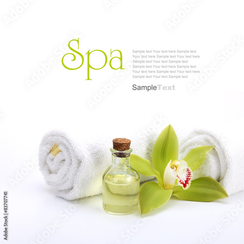 Fototapeta do kuchni Spa concept. Green orchid, oil and white towels.
