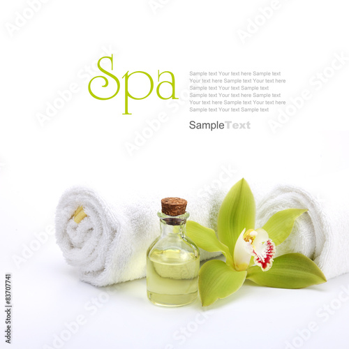 Naklejka na kafelki Spa concept. Green orchid, oil and white towels.