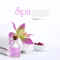 Spa concept. Pink orchid, oil, potpourri and white towels.