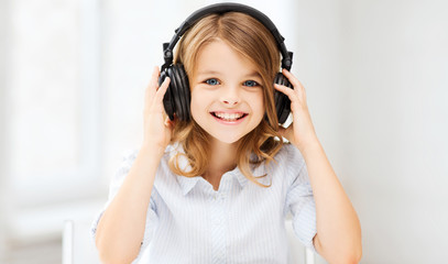 Canvas Print - little girl with headphones at home