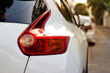 Back light of city car on the street background, soft focus