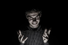 Man Portrait With Evil Look Isolated On Black Background.