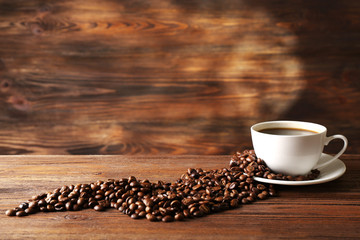 Poster - Cup of coffee with grains on wooden background