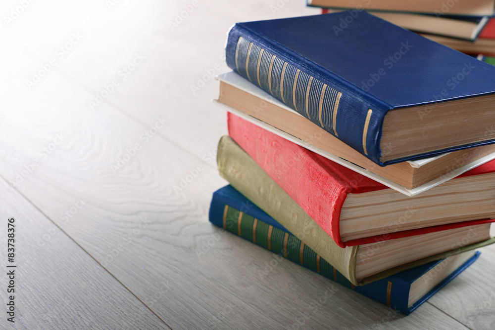 Stack of books on wooden background