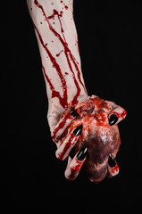 bloody hands with black nails holding bloody human heart