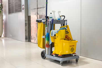 Yellow mop bucket and set of cleaning equipment