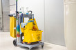 Yellow mop bucket and set of cleaning equipment