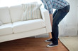 © Syda Productions - close up of male moving sofa or couch at home